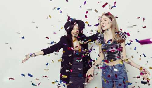 Studio lifestyle portrait of two best friends hipster girls wearing stylish outfits, going crazy and having great time together