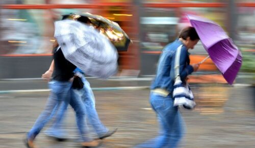 People walking down the street on a rainy day in motion blur